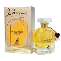 Maison Alhambra Precious Gold 80ml by Maison Alhambra — A gold box with black swirls and a deer logo sits next to a clear glass perfume bottle filled with golden liquid, featuring a gold cap and a yellow heart charm | Maison Alhambra Precious Gold 80ml oleh Maison Alhambra — Kotak emas dengan corak hitam berpusar dan