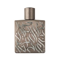 Rayhaan Rayhaan Woody Noir Eau De Parfum 100ml — A rectangular, taupe-colored perfume bottle with intricate, raised silver Arabic calligraphy covering its front surface and a metallic silver cap. | Rayhaan Rayhaan Woody Noir Eau De Parfum 100ml — Botol minyak wangi berbentuk segi empat, berwarna taupe dengan kaligrafi