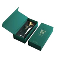 Bujairami Silent Halo by Bujairami 100ml Extrait — Green gift box open to reveal a clear glass perfume bottle with a gold cap, set against a white background.