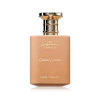 Paris Corner Taskeen Caramel Cascade 100ml — A light brown perfume bottle with a gold cap, featuring Arabic script and "Taskeen", "Caramel Cascade", and "PARIS CORNER" text. | Paris Corner Taskeen Caramel Cascade 100ml — Botol minyak wangi coklat muda dengan penutup emas, menampilkan tulisan Arab dan teks "Taskeen"