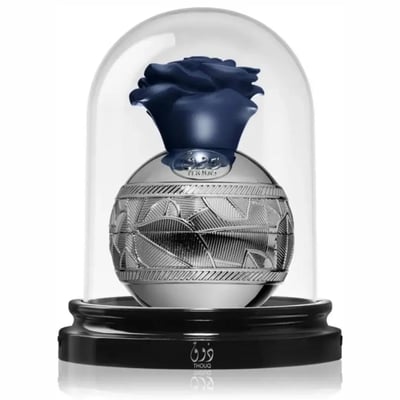 Lattafa Pride Thouq by Lattafa Pride 80ml EDP — A dark blue rose encased in a glass dome, resting on a silver spherical bottle with intricate leaf patterns, on a black base with Arabic and English text.