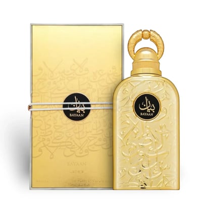 Lattafa Bayaan Eau De Parfum — Gold bottle and matching gold box with Arabic calligraphy design, tied with white string. | Lattafa Bayaan Eau De Parfum — Botol dan kotak emas sepadan dengan reka bentuk kaligrafi Arab, diikat dengan tali putih.