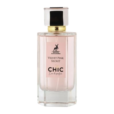 Maison Alhambra Chic Velvet Pink Secret for Women 100ml — A clear glass perfume bottle with pink liquid, a gold collar, and a clear cap with a black insert, set against a white background. | Maison Alhambra Chic Velvet Pink Secret for Women 100ml — Botol kaca jernih dengan cecair merah jambu, kolar emas, dan penutup