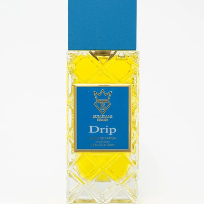 Bujairami Drip by Bujairami 100ml Extrait — Yellow liquid in a clear, diamond-patterned glass bottle with a blue cap and gold accents on the label.