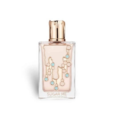 Maison Alhambra Sugar Me Marshmallow Dream — Rectangular glass perfume bottle with a gold, textured cap. The bottle contains pale pink liquid and features a decorative pattern of gold lines and light blue circles.