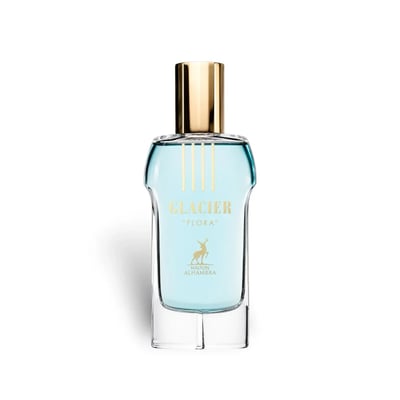 Maison Alhambra Glacier Flora 100ml — A clear glass perfume bottle with light blue liquid and a gold cap, featuring gold text and a deer logo. | Maison Alhambra Glacier Flora 100ml — Botol kaca jernih dengan cecair biru muda dan penutup emas, menampilkan teks emas dan logo rusa.
