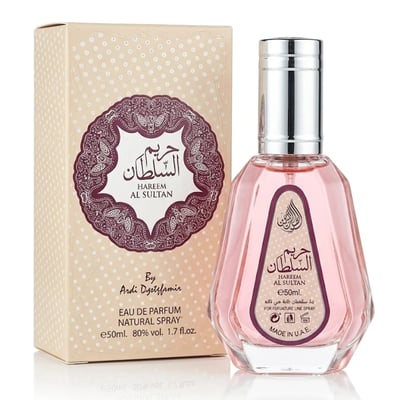 Ard Al Zaafaran Hareem Al Sultan EDP 50ml — A pink glass perfume bottle with a silver cap stands next to its beige patterned box with a maroon ornate circular label. | Ard Al Zaafaran Hareem Al Sultan EDP 50ml — Sebotol minyak wangi kaca berwarna merah jambu dengan penutup perak berdiri di sebelah kotak bercorak