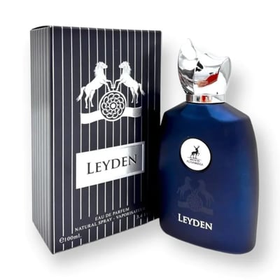 Maison Alhambra Leyden Eau De Parfum — A dark blue glass perfume bottle with a silver cap stands next to its matching dark striped box with white horses and a circular emblem. | Maison Alhambra Leyden Eau De Parfum — Botol kaca biru gelap dengan penutup perak berdiri di sebelah kotak berjalur gelap yang sepadan dengan