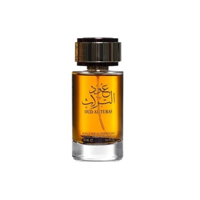 Ard Al Zaafaran Oud Al Turas 100ml by Ard Al Zaafaran — A clear glass perfume bottle with golden liquid and Arabic calligraphy on the label, topped with a textured gold cap. | Ard Al Zaafaran Oud Al Turas 100ml by Ard Al Zaafaran — Botol minyak wangi kaca jernih dengan cecair keemasan dan kaligrafi Arab pada label, di