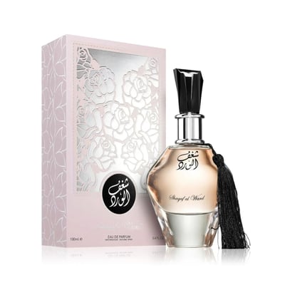 Al Wataniah Shagaf Al Ward — Pink patterned box with rose cutouts next to a glass perfume bottle with black tassel and black