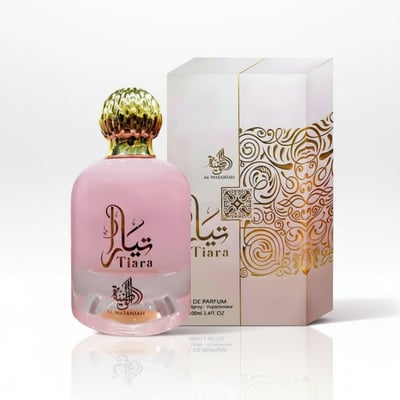 Al Wataniah Tiara Pink – Pink perfume bottle with gold cap and ornate box with gold scrollwork on a white background.