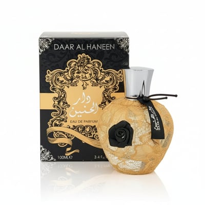 Ard Al Zaafaran Daar Al Haneen — Gold lace-covered perfume bottle with black rose accent next to its black and gold box.