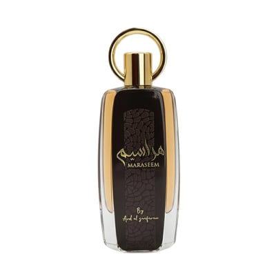 Ard Al Zaafaran Maraseem — Clear glass bottle with dark textured panel, gold accents, and a gold ring cap, isolated on white.
