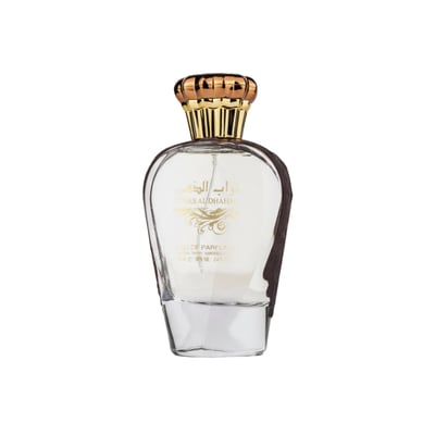 Ard Al Zaafaran Turab Al Dhahab — Clear glass perfume bottle with gold cap and dark brown accents, on a white background.