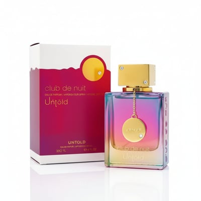 Armaf Club De Nuit Untold — A gradient iridescent perfume bottle with a gold cap sits next to its matching pink and gold box.