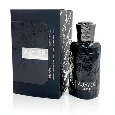 Lattafa Ajayeb Dubai by Lattafa EDP 100ml — Black textured bottle and matching box with marble-like design, set against a white background.