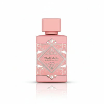 Lattafa Badee Al Oud Noble Blush — Pink perfume bottle with ornate silver geometric label and pink cap, isolated on white.