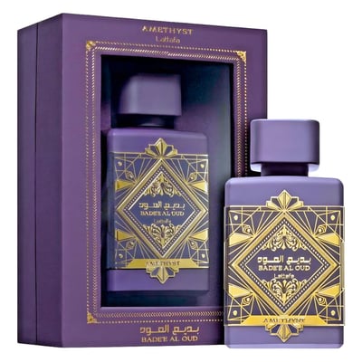 Lattafa Badee Al Oud Amethyst — Purple gift box with gold trim holding a purple perfume bottle, another bottle beside it.