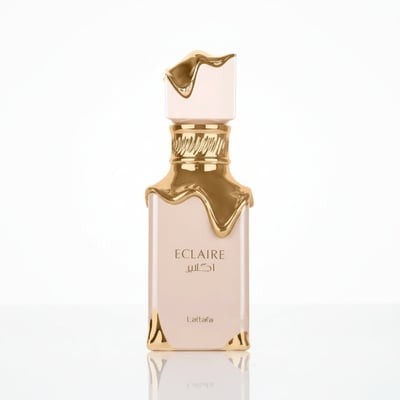 Lattafa Eclaire — A pale pink perfume bottle with gold dripping accents and a gold ridged collar, against a white background.