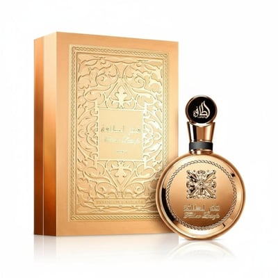 Lattafa Fakhar Extrait — Gold embossed box and round perfume bottle with ornate design and Arabic script.