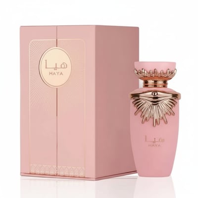 Lattafa Haya by Lattafa Perfumes – 100 ml for Women. A pink perfume bottle with a gold sunburst-like design on the neck, next to its matching pink presentation box with gold accents.