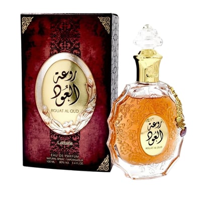 Lattafa Rouat Al Oud by Lattafa 100ml EDP Unisex — A maroon and gold patterned box sits next to a clear glass perfume bottle with amber liquid and a gold cap, featuring ornate detailing and a hanging charm.