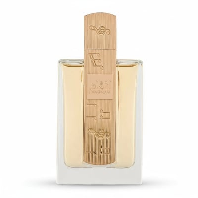Lattafa Angham — Clear glass perfume bottle with gold cap and decorative band featuring musical notes and Arabic script.