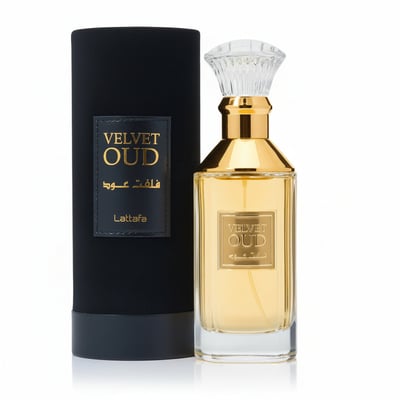 Lattafa Velvet Oud by Lattafa 100ml Unisex — Gold bottle of Velvet Oud perfume with a clear faceted cap, next to its black cylindrical presentation box with gold lettering.