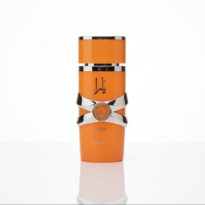 Lattafa Yara Tous by Lattafa 100ml EDP Women — Orange perfume bottle with silver accents and Arabic script, against a white background with reflection.