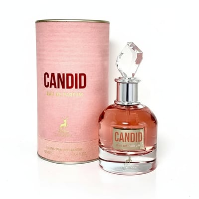 Maison Alhambra Candid Eau de Parfum — Pink textured cylindrical box and a clear glass perfume bottle with rose gold liquid and a faceted crystal cap, set against a white background.
