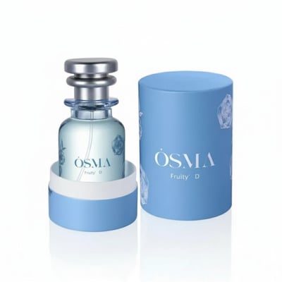 Osma Fruity D Cherry & Oud 75ml EDP — Light blue perfume bottle with silver cap, placed inside a light blue cylindrical box with rose motifs, against a white background.