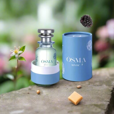 Osma White F Berries & Flowers 75ml EDP — Perfume bottle with silver cap and blue holder, next to a blue cylindrical box, with a blackberry and a white flower in the background.