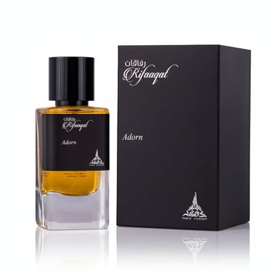 Paris Corner Rifaaqat Adorn by Paris Corner 85ml EDP — Black perfume box with gold accents next to a clear glass perfume bottle with gold cap and black label.
