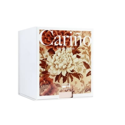 Rue Broca Carino White Pour Femme 100ml EDP — White box with floral pattern featuring large white and red flowers, text 'Carino eau de parfum' and 'ICA MESQO'.