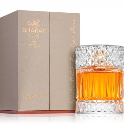 Zimaya Sharaf Blend by Zimaya 100ml Extrait de Parfum — Amber liquid in a faceted glass bottle with a textured gold cap, next to its beige presentation box with gold lettering.