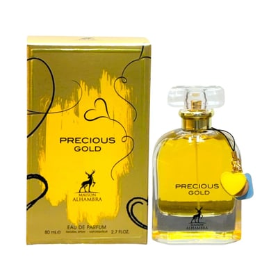 Maison Alhambra Precious Gold 80ml by Maison Alhambra — A gold box with black swirls and a deer logo sits next to a clear glass perfume bottle filled with golden liquid, featuring a gold cap and a yellow heart charm | Maison Alhambra Precious Gold 80ml oleh Maison Alhambra — Kotak emas dengan corak hitam berpusar dan