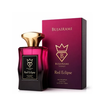 Bujairami Red Eclipse — Pink gradient glass perfume bottle with gold cap, next to its matching magenta box with gold logo and text, on a white background.