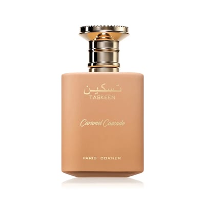 Paris Corner Taskeen Caramel Cascade 100ml — A light brown perfume bottle with a gold cap, featuring Arabic script and "Taskeen", "Caramel Cascade", and "PARIS CORNER" text. | Paris Corner Taskeen Caramel Cascade 100ml — Botol minyak wangi coklat muda dengan penutup emas, menampilkan tulisan Arab dan teks "Taskeen"