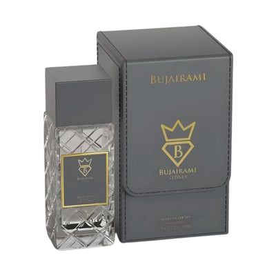 Bujairami World Power Oud Cacao Leather 100ml Extrait — Clear faceted glass perfume bottle with grey cap next to a grey presentation box with gold embossed logo and text