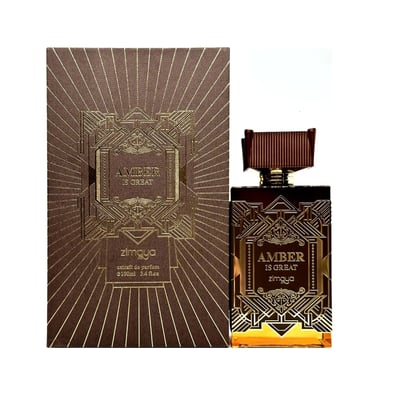 Zimaya Amber Is Great Eau De Parfum 100ml — A brown textured box with gold geometric art deco design stands next to a rectangular glass perfume bottle with a ribbed brown cap and gold geometric art deco design. The bottle contains amber-colored liquid. | Zimaya Amber Is Great Eau De Parfum 100ml — Kotak bertekstur