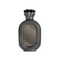 Zimaya Daiman Eclipse Eau De Parfum 100ml by Zimaya — A dark grey oval perfume bottle with a textured surface and a metallic grey cap, featuring a central metallic plaque with intricate line art and Arabic-style lettering. | Zimaya Daiman Eclipse Eau De Parfum 100ml by Zimaya — Botol minyak wangi bujur kelabu gelap