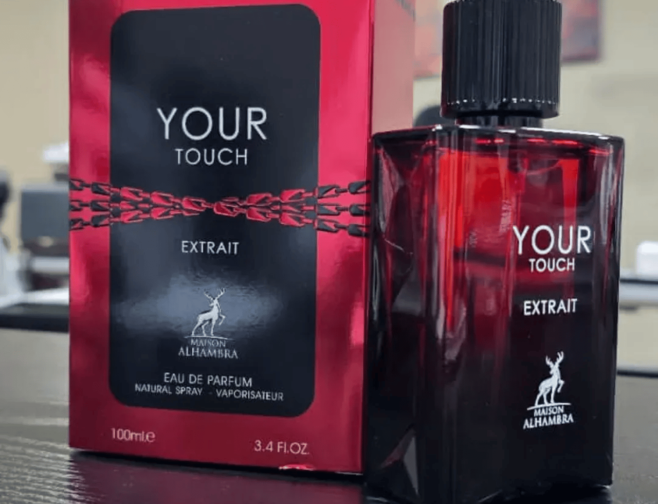 Maison Alhambra Your Touch Extrait — Kotak merah dan botol kaca merah gelap Your Touch Extrait by Maison Alhambra 100ml Extrait de Parfum, dengan logo rusa.