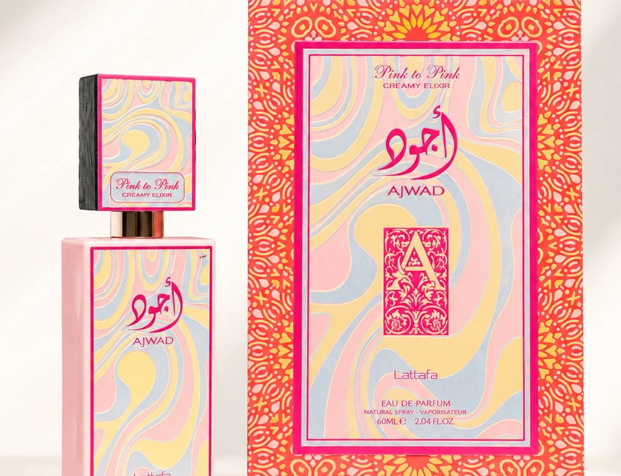 Lattafa Ajwad Pink 2 Pink Creamy Elixir — Botol minyak wangi merah jambu dengan penutup bercorak bersebelahan kotak padanannya, kedua-duanya menampilkan warna pastel berombak dan tulisan Arab.