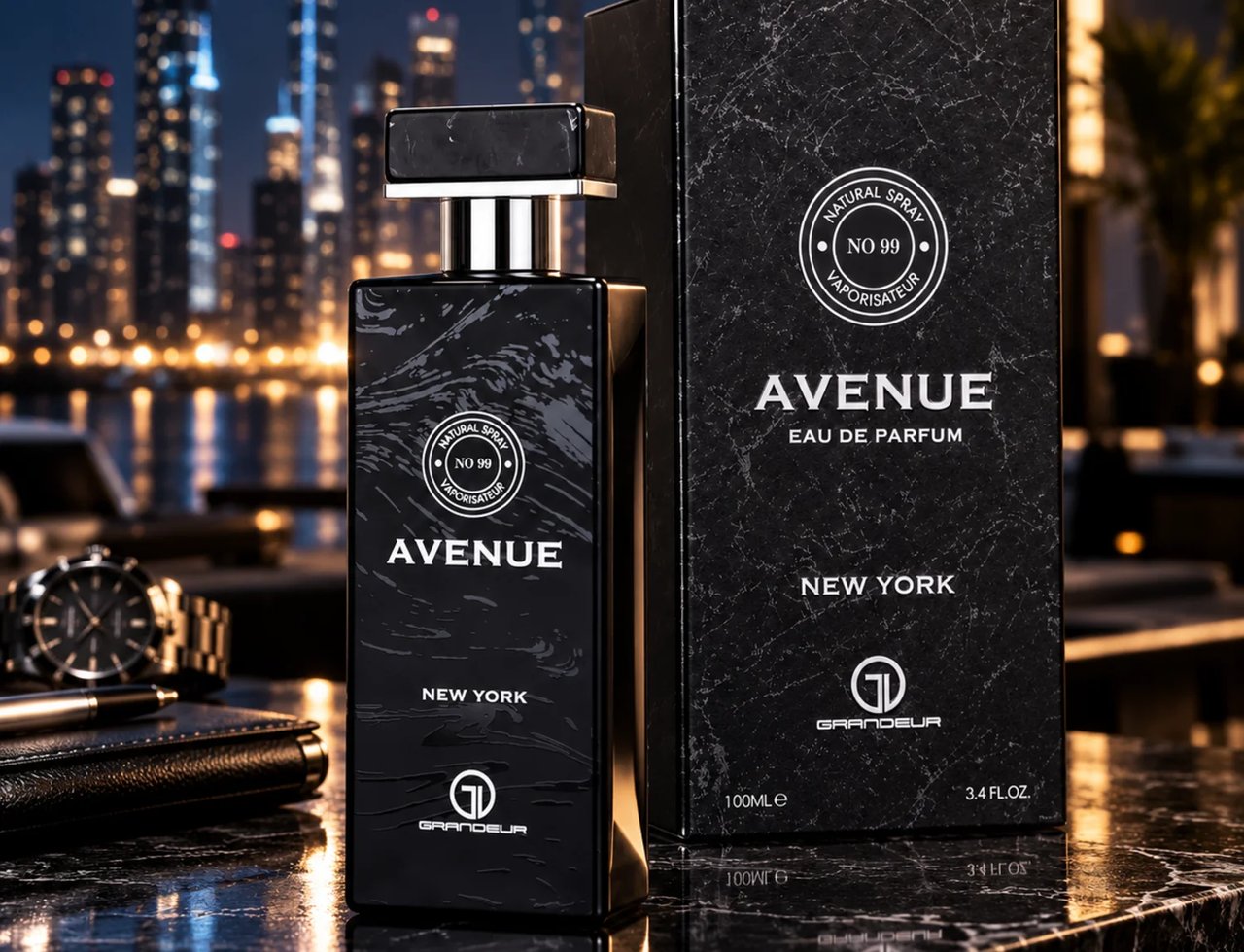 Grandeur Avenue New York EDP Men — Black marble patterned bottle and box with gold accents, set against a blurred city skyline at night. A watch and notebook are visible.
