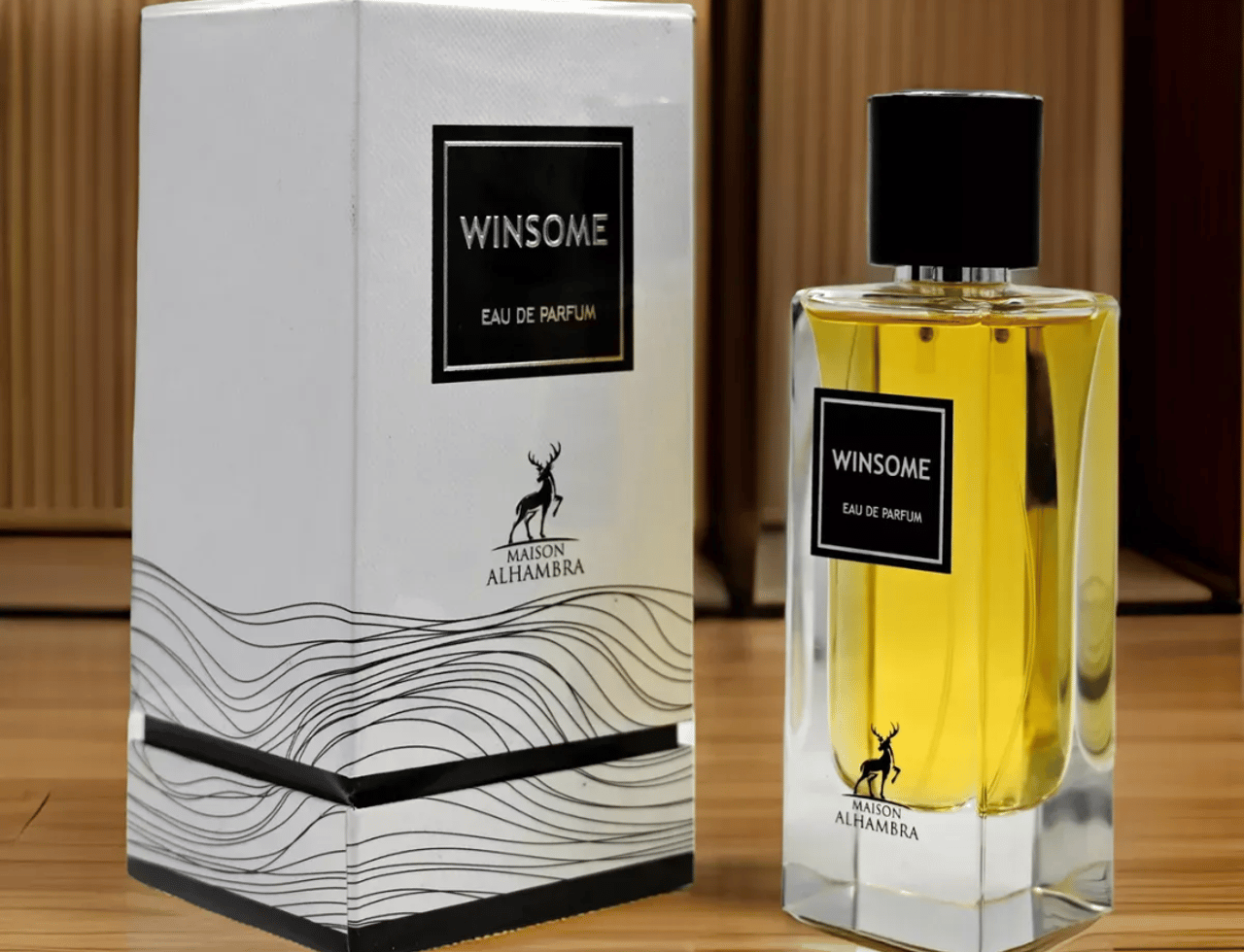 Maison Alhambra Winsome by Maison Alhambra 90ml EDP — A white box with wavy lines and a deer logo sits next to a clear glass perfume bottle filled with golden liquid, both featuring the 'Winsome Eau de Parfum' label.