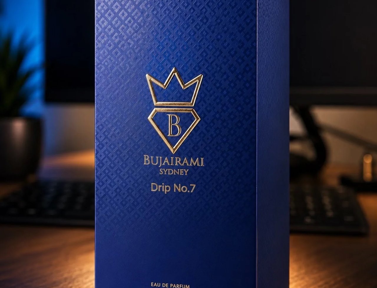 Bujairami Drip No. 7 — Blue textured box with gold crown logo and text, featuring 'Bujairami Sydney Drip No. 7' and 'Eau de Parfum 3.4 FL.OZ./100 ml e'.