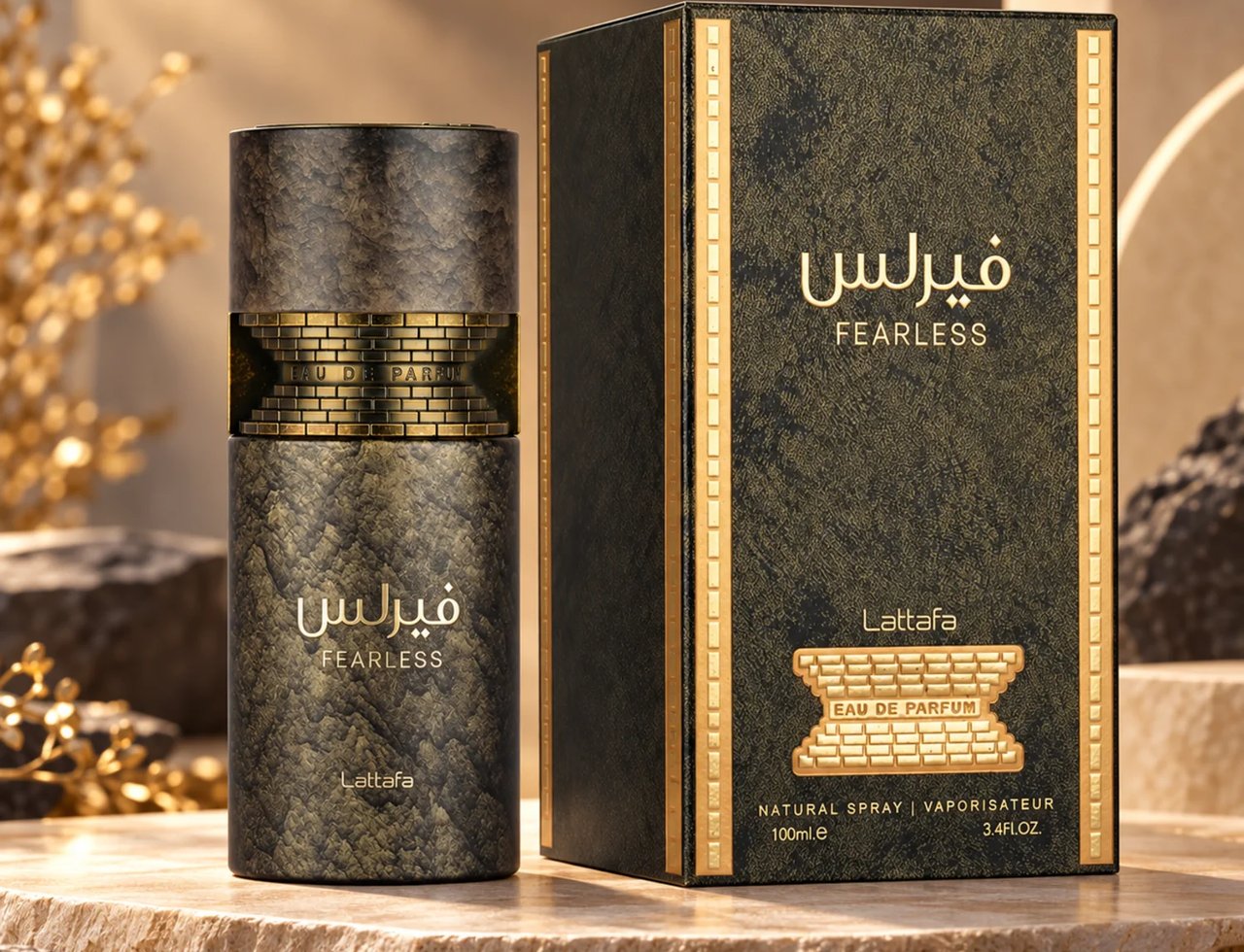 Lattafa Fearless by Lattafa 100ml EDP Men — A textured dark bottle with gold accents and Arabic script, next to its matching dark textured box with gold trim, set on a stone surface with blurred golden foliage.