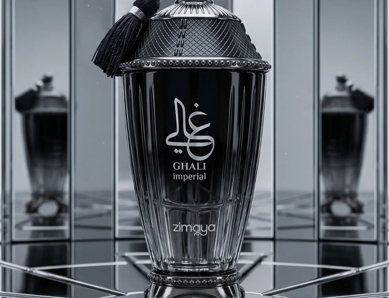 Zimaya Ghali Imperial Eau De Parfum 100ml by Zimaya — Black fluted glass bottle with a silver ornate cap and black tassel, set against a mirrored background with reflections of the bottle. | Zimaya Ghali Imperial Eau De Parfum 100ml by Zimaya — Botol kaca hitam berlekuk dengan penutup perak berhias dan rumbai hitam