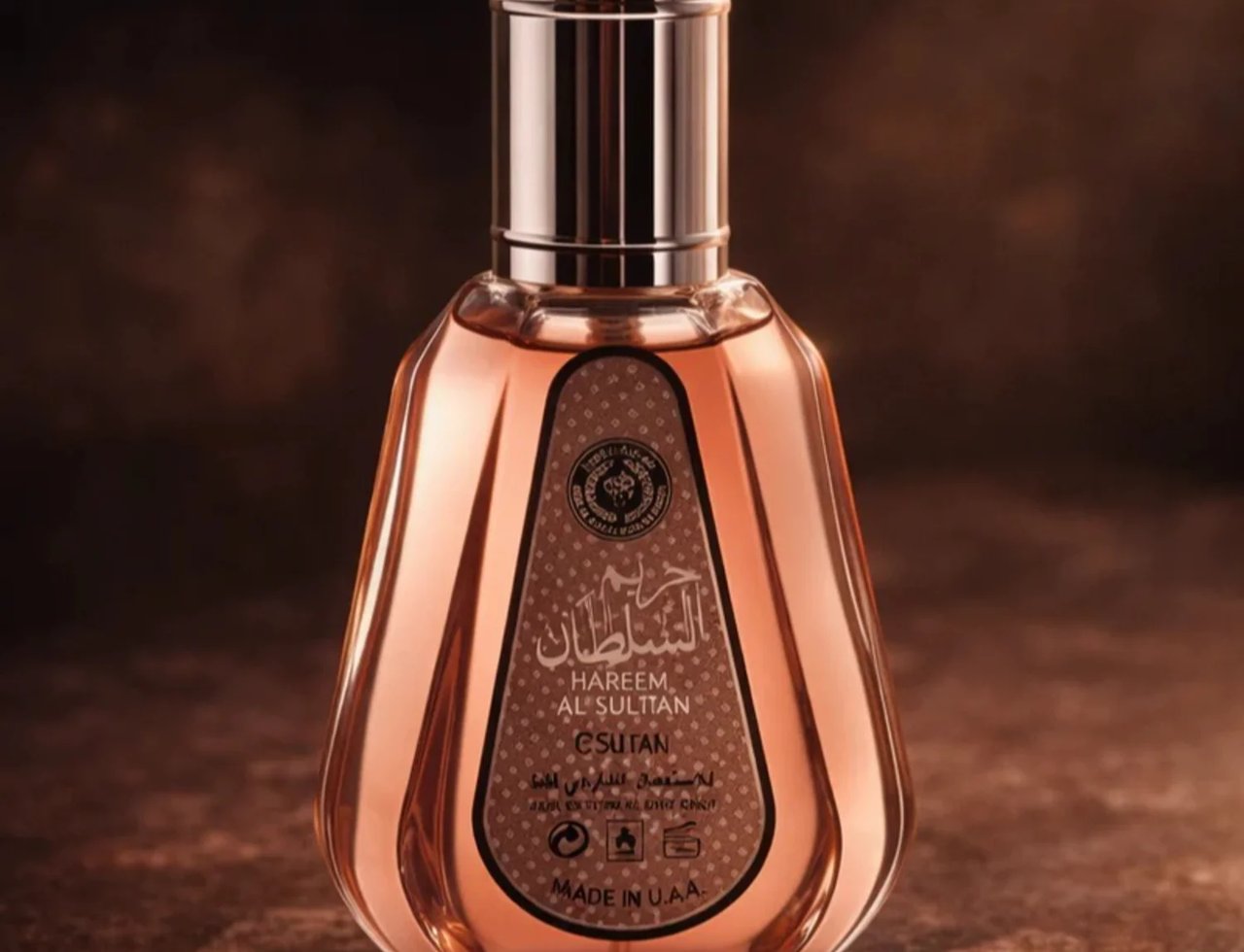 Ard Al Zaafaran Hareem Al Sultan EDP 50ml — Botol kaca lutsinar berisi cecair berwarna oren kemerahan, dengan penutup logam berkilat. Label berona coklat gelap dengan tulisan Arab dan Inggeris.