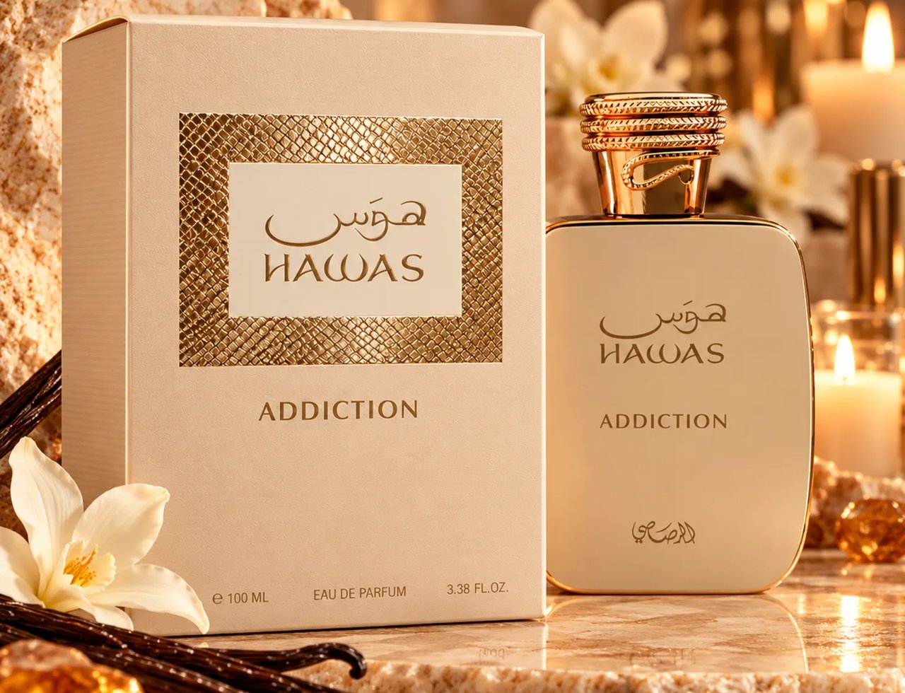 RASASI Hawas Addiction by Rasasi 100ml EDP — A cream-colored perfume box and bottle with gold accents, set against a backdrop of textured rocks, vanilla pods, a white flower, and lit candles.
